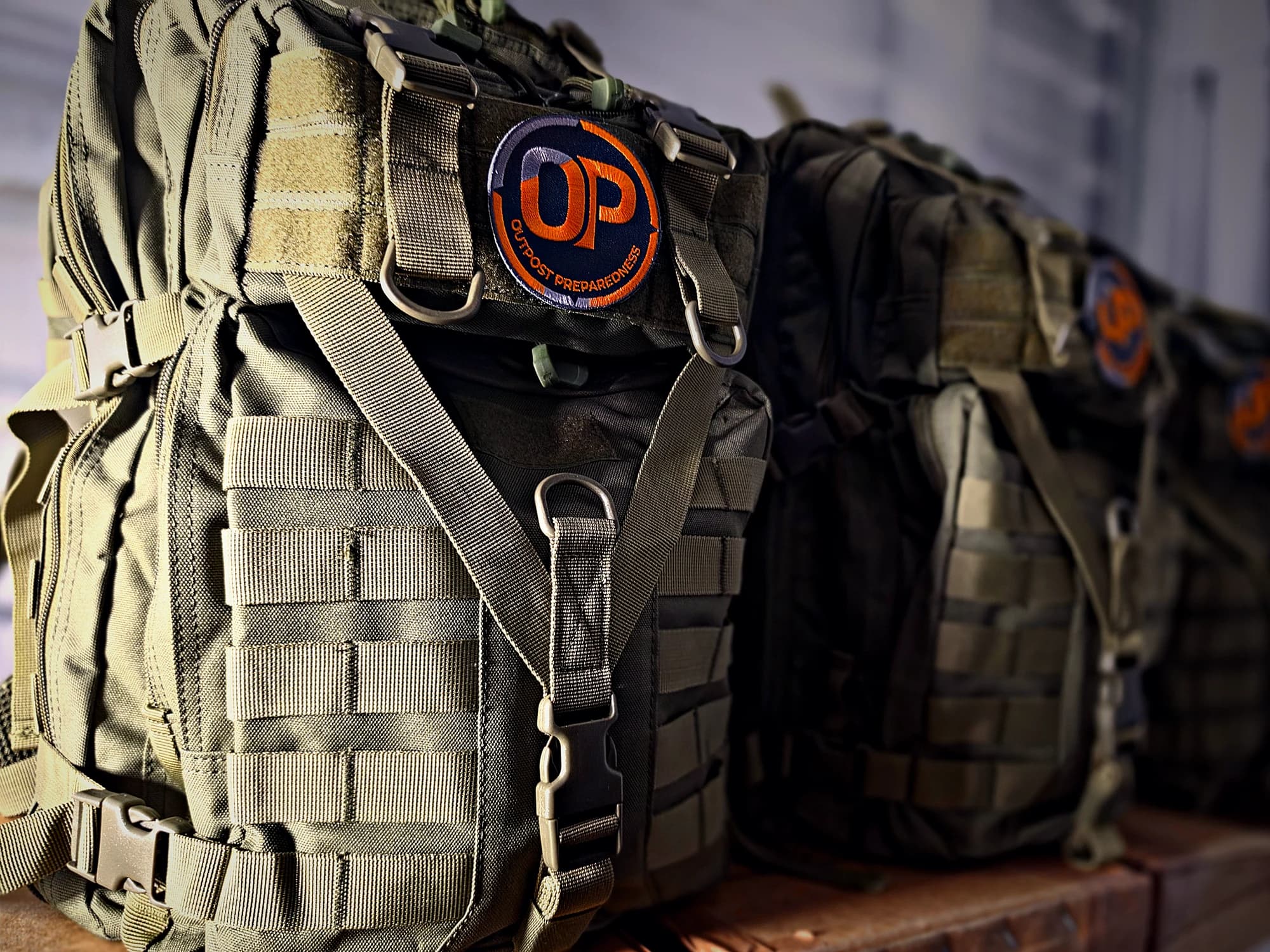 Packed Outpost Essential+ Go-Bags lined up in the warehouse