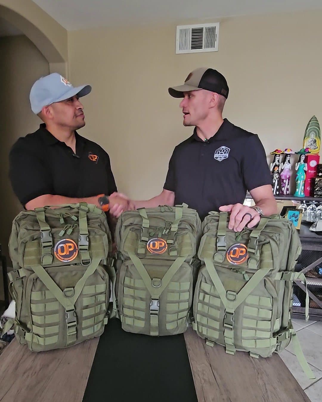 Drew Jennings and Brian, President & Co-Founder of No Lone Wolves, shake hands over the Go-Bags