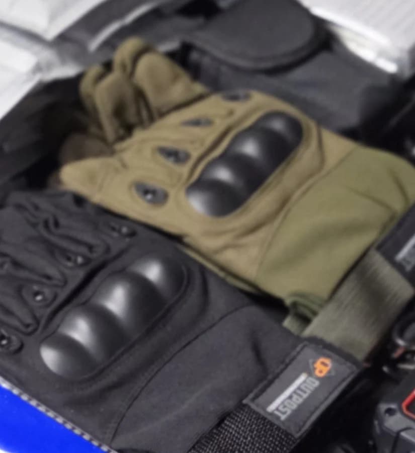 Two pairs of carbon-knuckle work gloves laid out before packing
