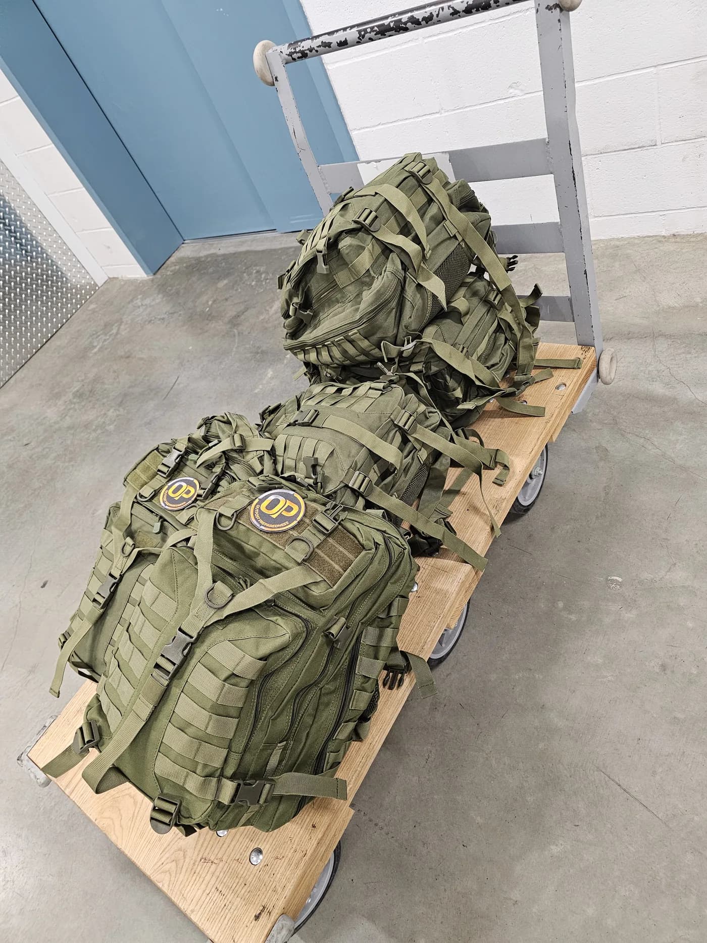 A row of finished Outpost go-bags on a pallet, ready to ship