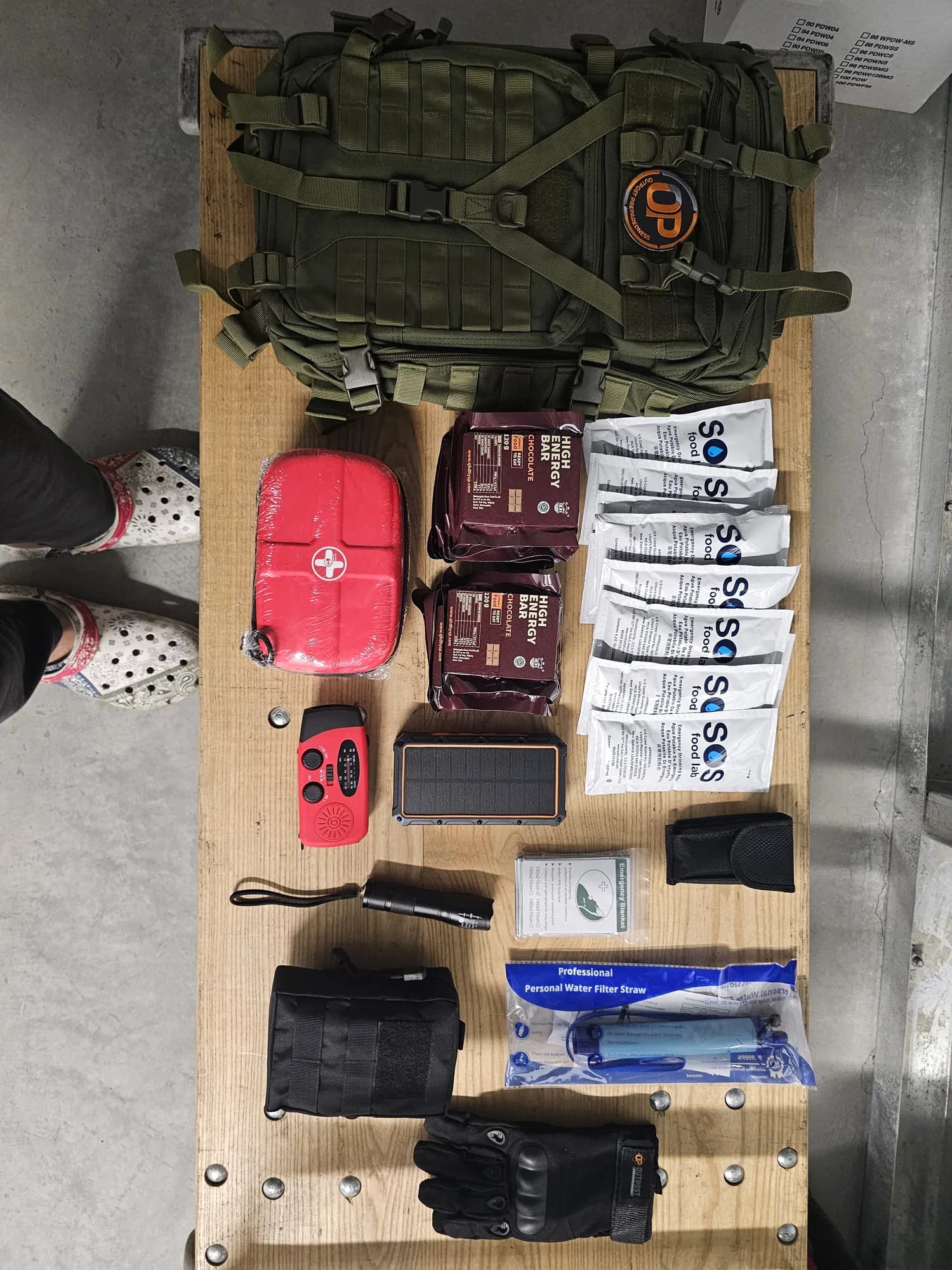 A go-bag and its full component set laid out for a large-order build