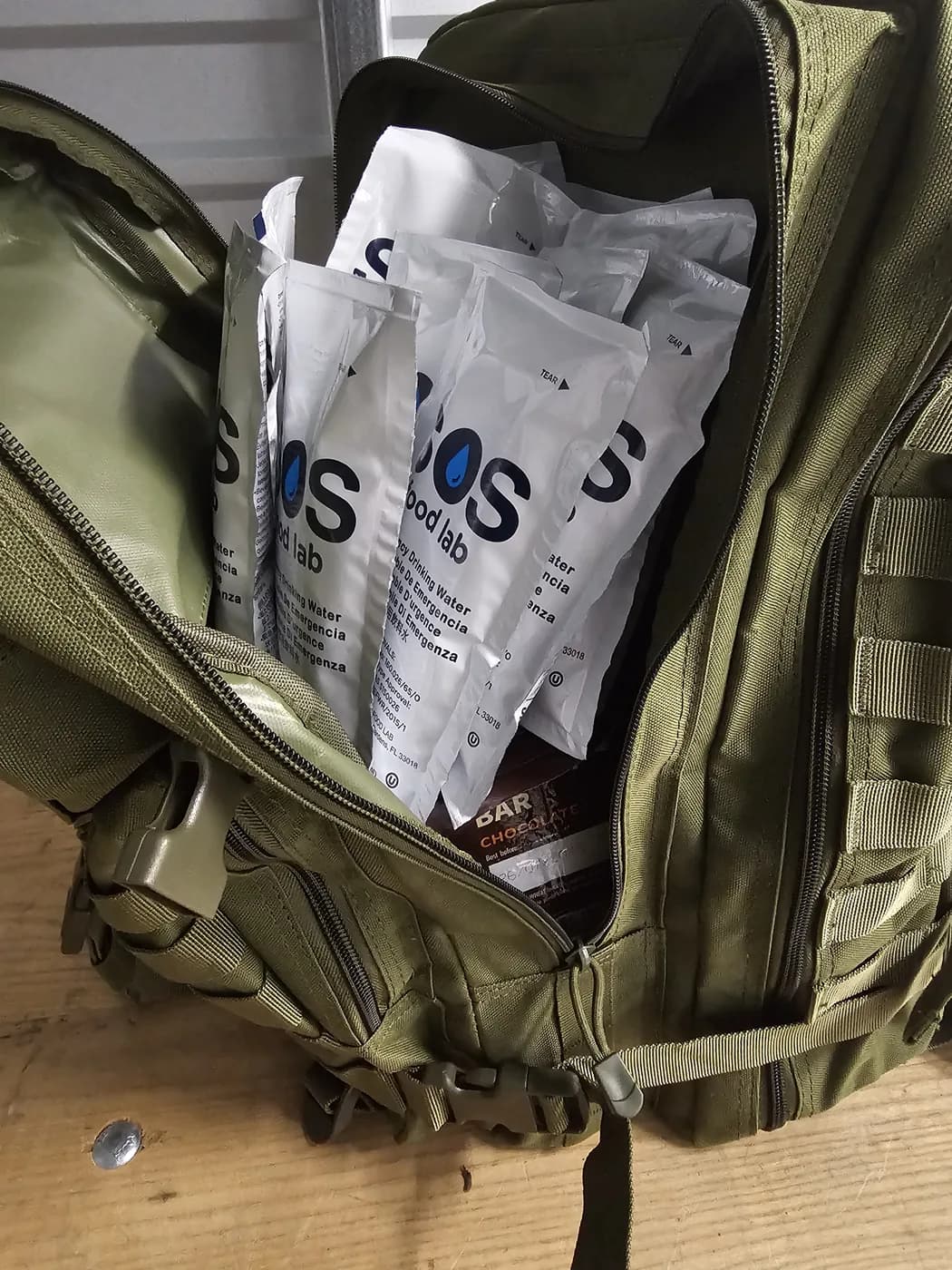 Emergency water pouches being packed into a go-bag